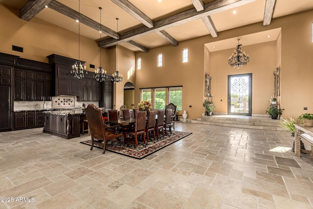 dining space featuring an inviting chandelier, stone tile floors, arched walkways, and beamed ceiling