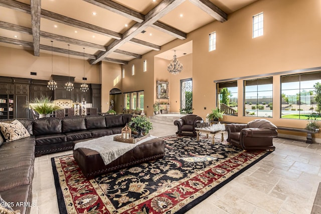 living area with a chandelier, coffered ceiling, a towering ceiling, beamed ceiling, and stone tile flooring