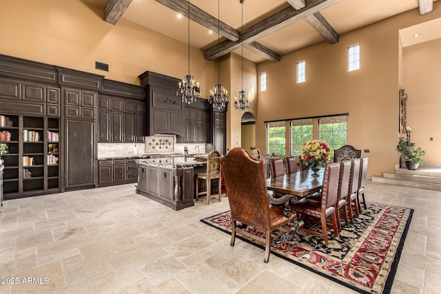 dining space featuring stone tile floors, beam ceiling, visible vents, and a notable chandelier