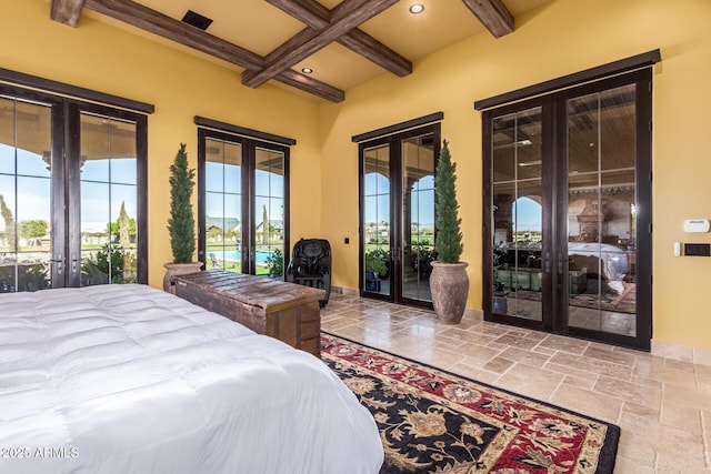 bedroom with access to exterior, french doors, beamed ceiling, and stone tile floors