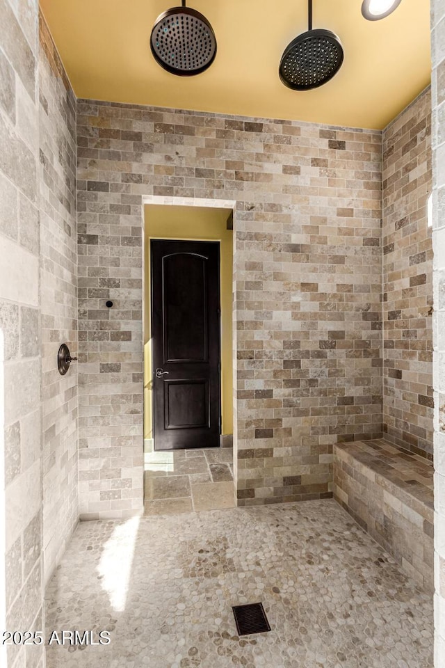 bathroom with tiled shower