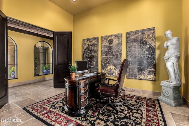 office area with recessed lighting, stone tile flooring, and baseboards