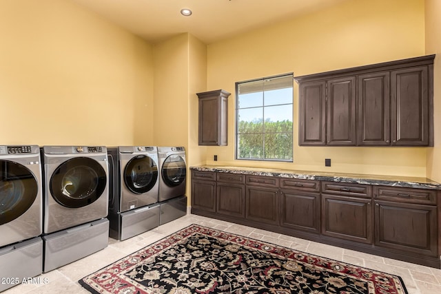 laundry room featuring cabinet space, light tile patterned floors, washer and dryer, and recessed lighting