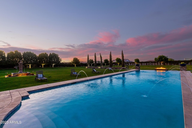 outdoor pool featuring a lawn