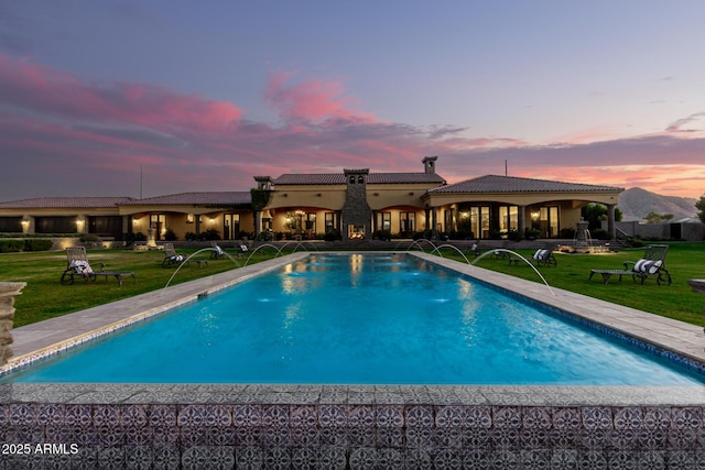 outdoor pool with a lawn