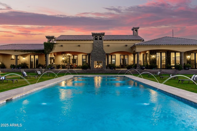 pool at dusk with an outdoor pool