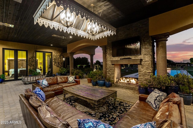 view of patio / terrace with an outdoor living space with a fireplace