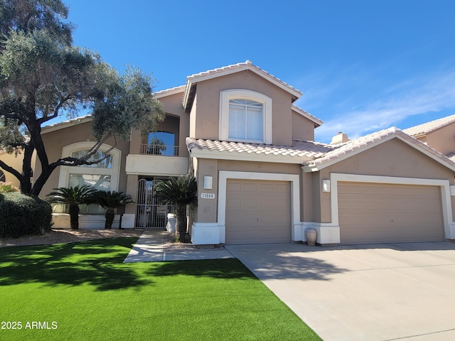 view of front of home featuring concrete driveway, a tiled roof, a front lawn, and stucco siding