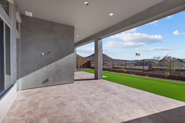 view of patio / terrace featuring visible vents and fence