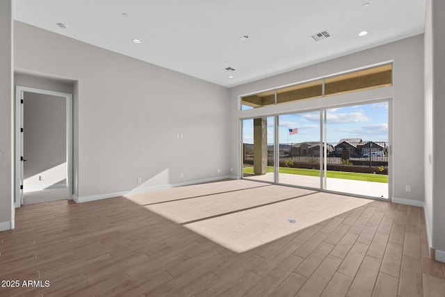 interior space featuring recessed lighting, visible vents, baseboards, and wood finished floors