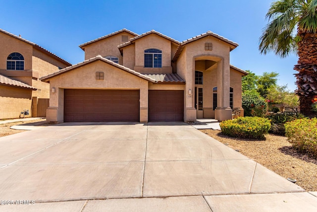 2741 E San Tan St, Chandler, AZ 85225 - mediterranean / spanish house with stucco siding, a tiled roof, concrete driveway, and an attached garage