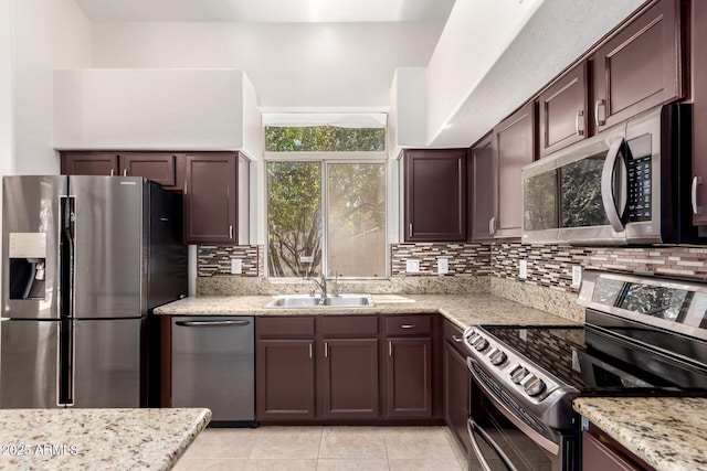 2741 E San Tan St, Chandler, AZ 85225 - kitchen featuring stainless steel appliances, backsplash, light stone countertops, light tile patterned flooring, and dark brown cabinets