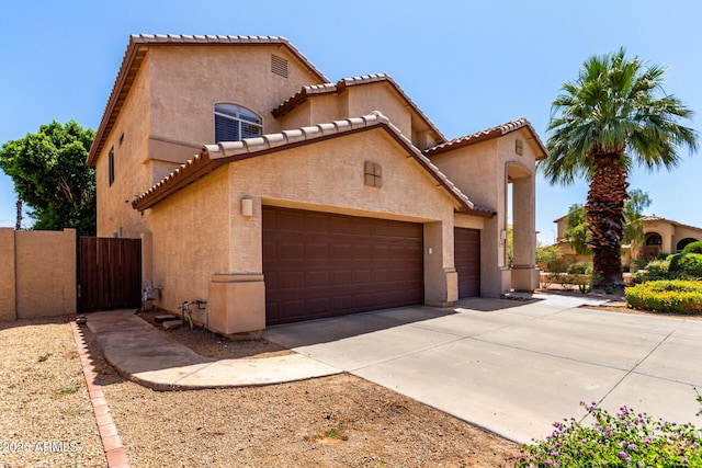 2741 E San Tan St, Chandler, AZ 85225 - mediterranean / spanish home featuring an attached garage, stucco siding, a tile roof, and driveway