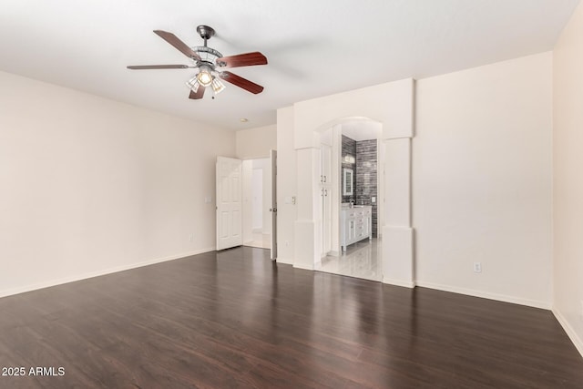 2741 E San Tan St, Chandler, AZ 85225 - empty room featuring a ceiling fan, arched walkways, and wood finished floors