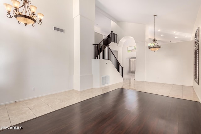 2741 E San Tan St, Chandler, AZ 85225 - foyer entrance with wood finished floors, stairs, arched walkways, a chandelier, and a high ceiling