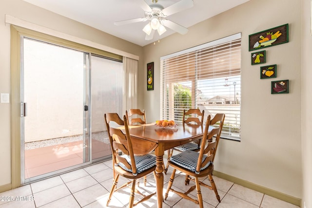 dining area featuring light tile patterned floors, baseboards, and ceiling fan