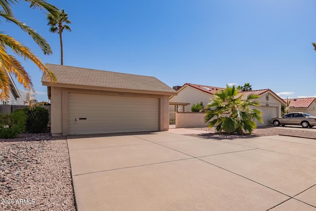 view of front of property with fence, a garage, and stucco siding