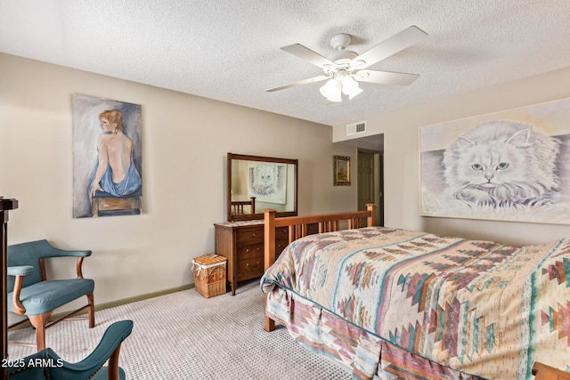 bedroom featuring a ceiling fan, baseboards, visible vents, a textured ceiling, and carpet flooring