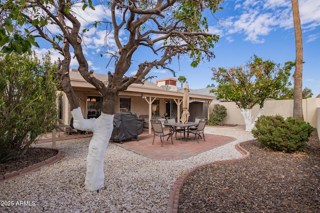 back of house with stucco siding, a patio, and a fenced backyard