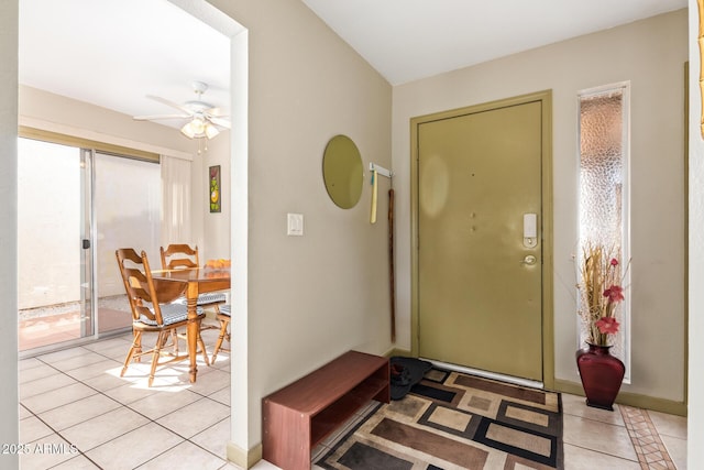 foyer featuring light tile patterned flooring and a ceiling fan