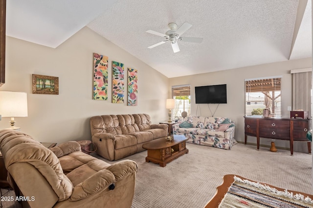 carpeted living room featuring vaulted ceiling, a ceiling fan, and a textured ceiling