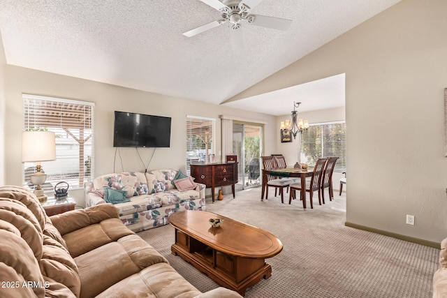 living room featuring ceiling fan with notable chandelier, a textured ceiling, baseboards, light colored carpet, and vaulted ceiling