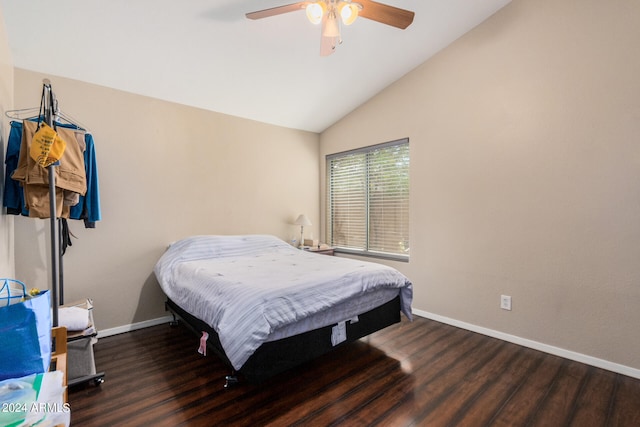 bedroom featuring dark hardwood / wood-style floors, vaulted ceiling, and ceiling fan