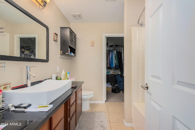 bathroom with vanity, toilet, and tile patterned floors