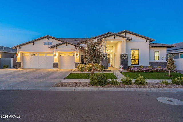 view of front of house with a garage, a front yard, driveway, and stucco siding