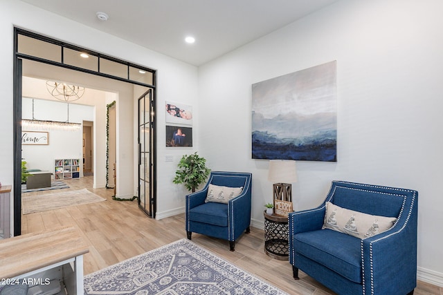 sitting room with baseboards and wood finished floors