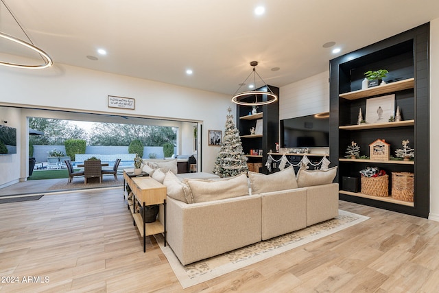 living area with light wood-style floors and recessed lighting