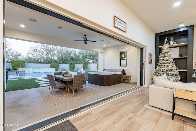 interior space featuring a ceiling fan, outdoor dining area, and a jacuzzi