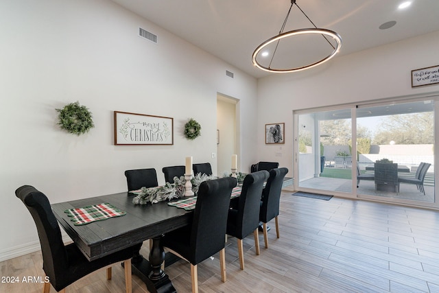 dining space with recessed lighting, visible vents, and light wood-style flooring