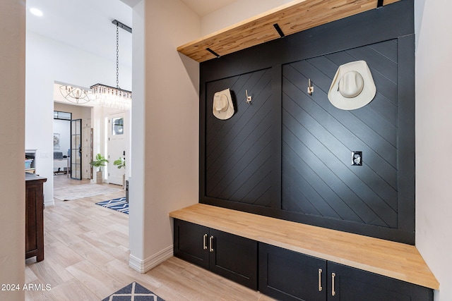 mudroom with light wood-style flooring and baseboards