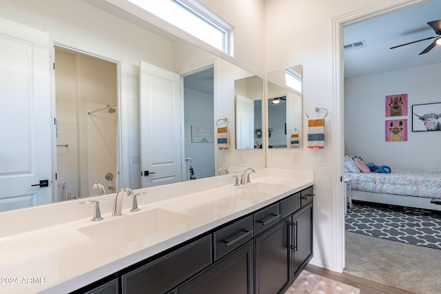 full bath with double vanity, ceiling fan, visible vents, and a sink