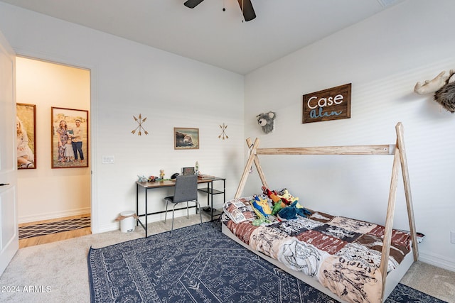 carpeted bedroom with a ceiling fan and baseboards