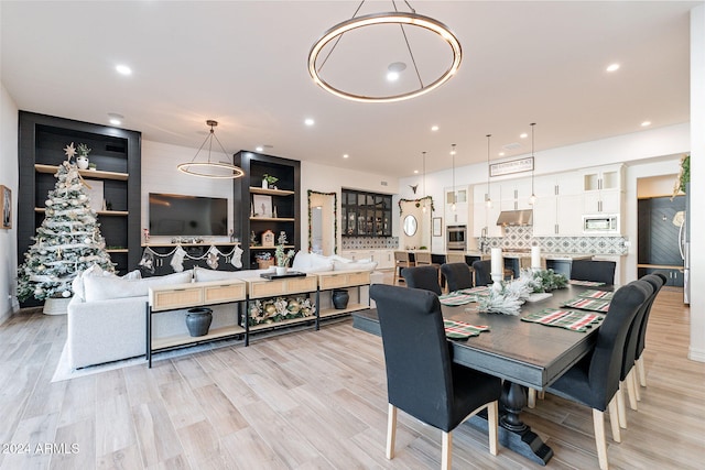 dining area with recessed lighting and light wood-style flooring