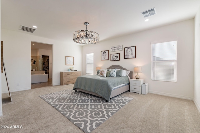 bedroom with light carpet, visible vents, and a chandelier