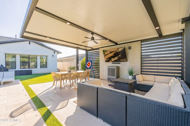 view of patio with heating unit, outdoor lounge area, a ceiling fan, and outdoor dining space