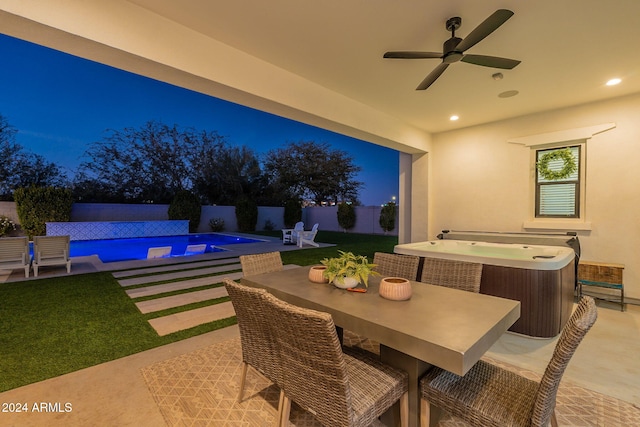 view of patio featuring ceiling fan, fence, a fenced in pool, outdoor dining space, and a hot tub