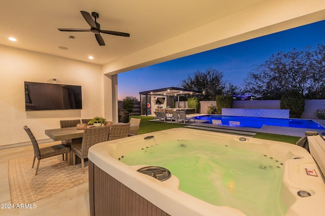 view of patio with a fenced in pool, an outbuilding, a hot tub, a ceiling fan, and a fenced backyard