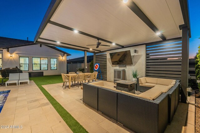 view of patio / terrace featuring ceiling fan, an outdoor living space with a fireplace, fence, and outdoor dining area