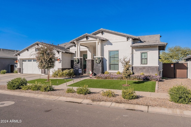 view of front of home with stucco siding, a garage, driveway, a tiled roof, and a front lawn