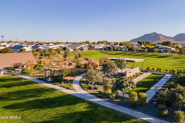 view of property's community with a yard, a residential view, and a mountain view