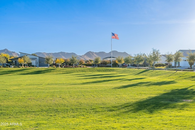 view of property's community featuring a mountain view and a lawn