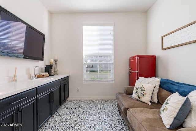 living room featuring light tile patterned flooring and baseboards