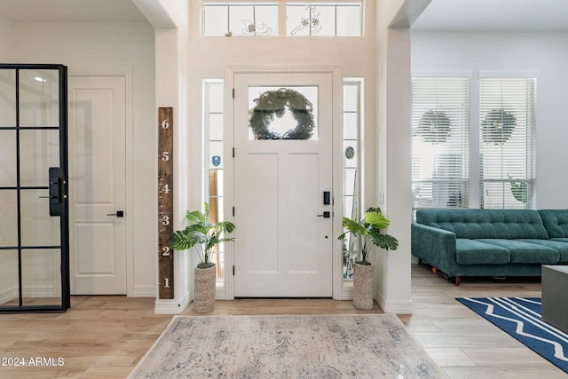 entrance foyer featuring light wood finished floors and baseboards