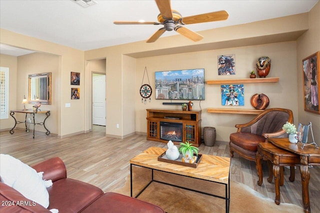 living room with ceiling fan and light hardwood / wood-style flooring