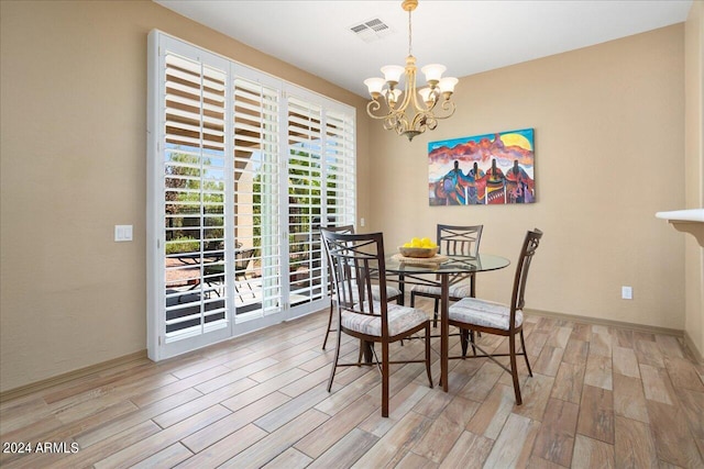 dining room featuring a chandelier and light wood-type flooring