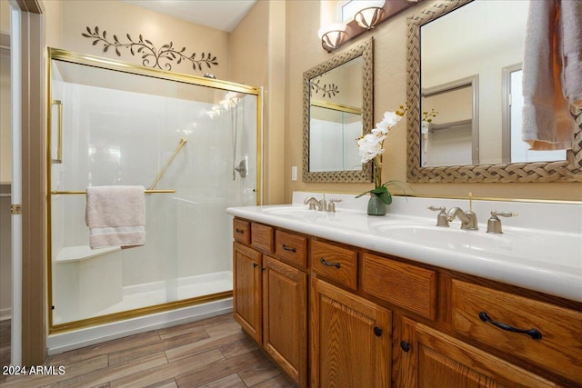 bathroom with vanity, an enclosed shower, and hardwood / wood-style floors